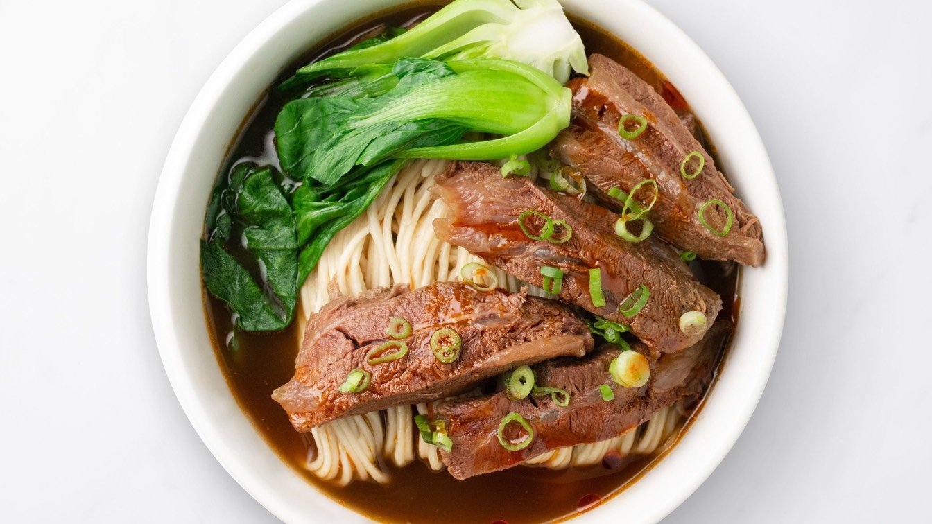 Braised Beef Noodle Soup in a white bowl