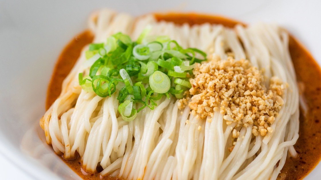 Noodles with Sesame Sauce in a white bowl, close up