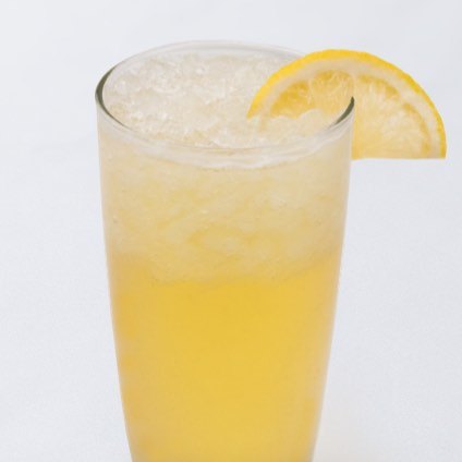 A photo of ice honey lemonade with a lemon slice garnish in a glass.
