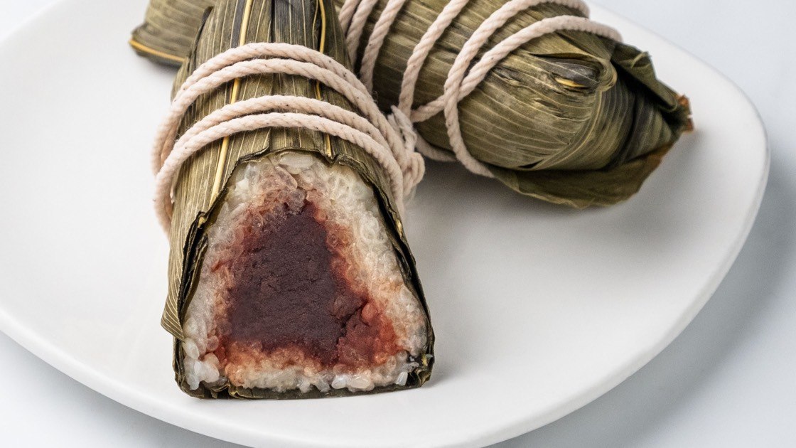 Red Bean Sticky Rice Wrap on a white plate, close up