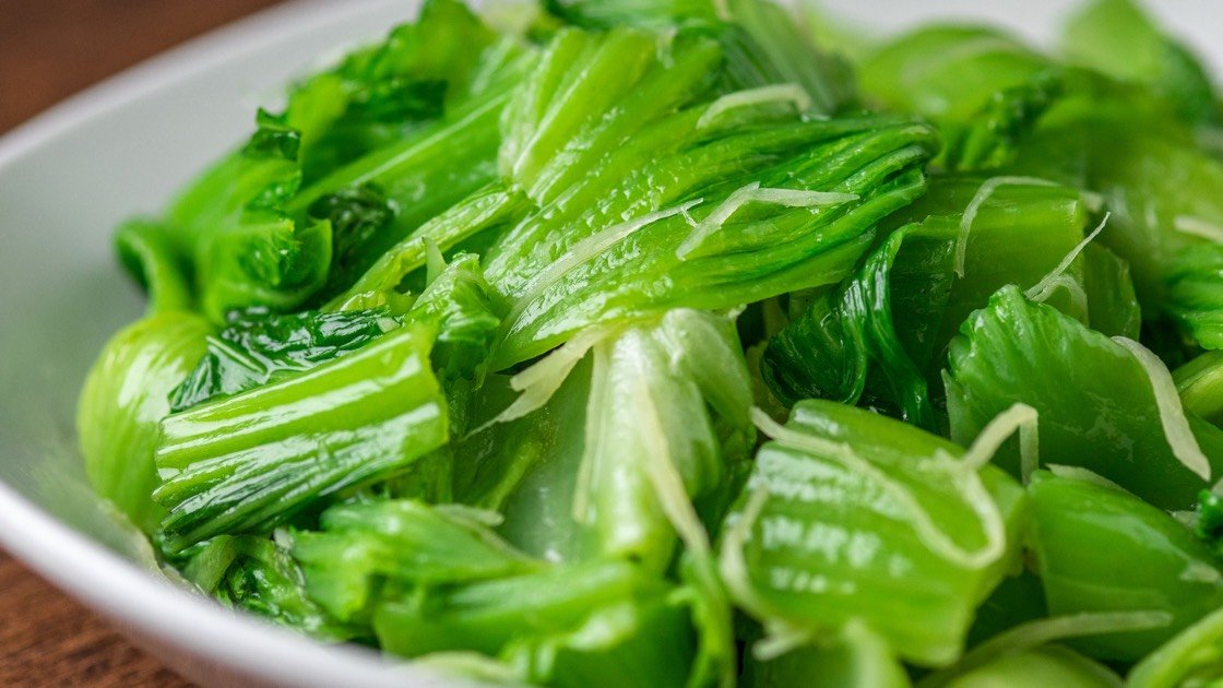 Sauteed Mustard Greens with Shredded Ginger Steamer in a white bowl, detail