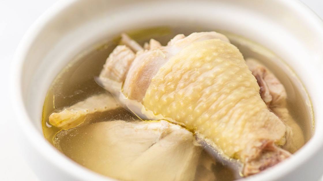 House Jidori Chicken Soup (Steamed) in a white bowl, close up