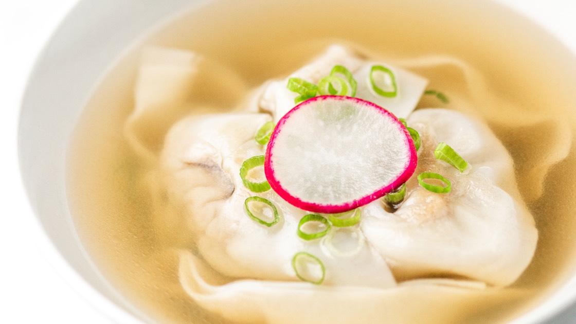 Jidori Chicken Wonton Soup in a white bowl, close up