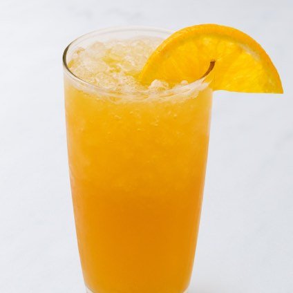 A photo of a fresh orange green tea in a glass.