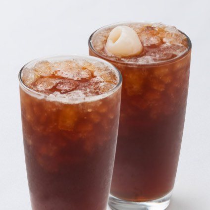 Two tall glasses of iced black tea and lychee black tea. 