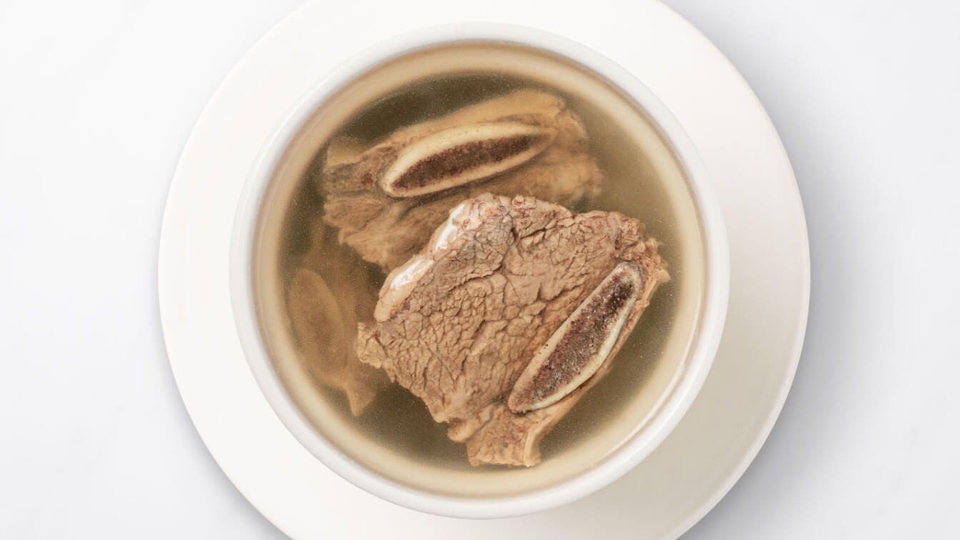 House Beef Soup (Steamed) in a white bowl