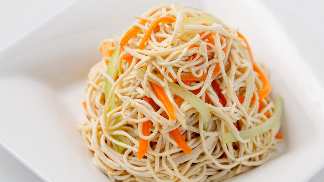 Soy Noodle Salad in a white bowl, close up